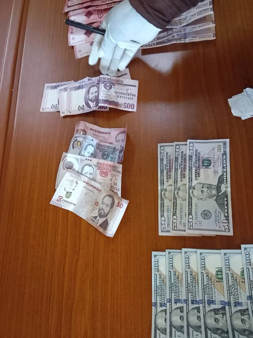 A gloved officer counts the notes recovered from the cab
